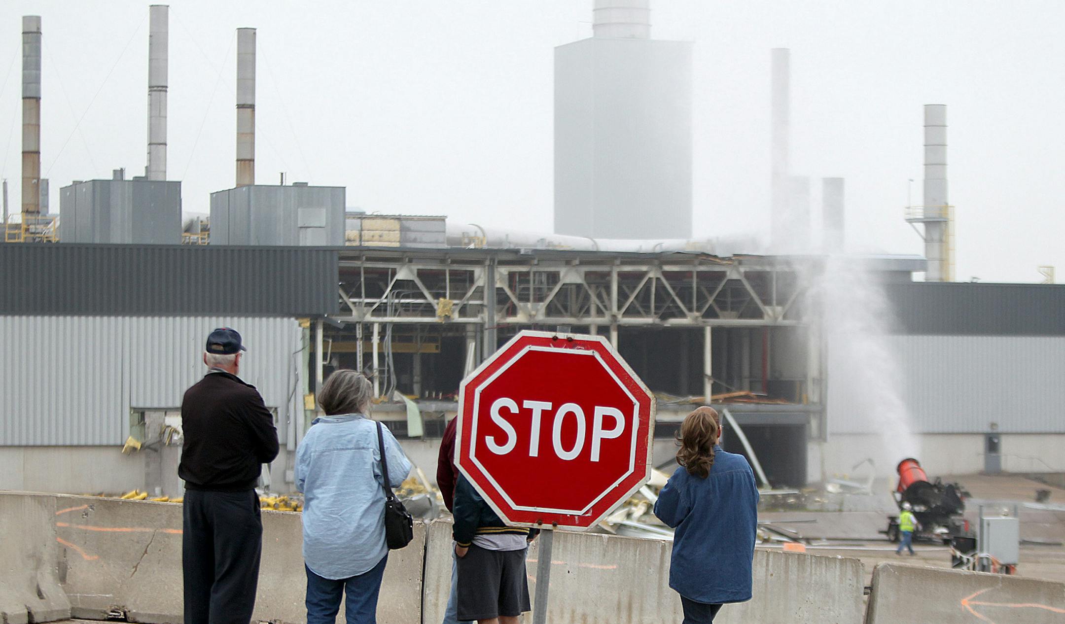 People watched as demolition crew took down the paint building of the 150-acre former Twin Cities Ford Assembly Plant, Monday, June 10, 2013 in St. Paul, MN. The Ford company has played an important role in St. Paul for nearly 90 years. (ELIZABETH FLORES/STAR TRIBUNE) ELIZABETH FLORES ¬• eflores@startribune.com ORG XMIT: MIN1306100951245090