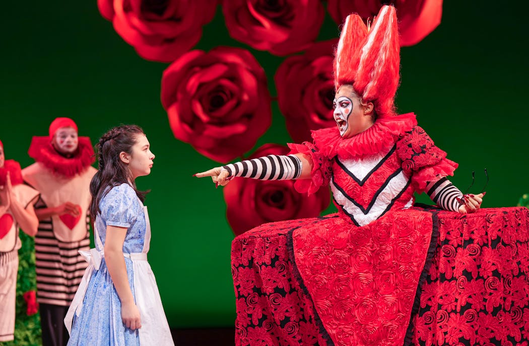 Alice (Audrey Mojica) is terrified by the Queen of Hearts (China Brickey) in “Alice in Wonderland.” 