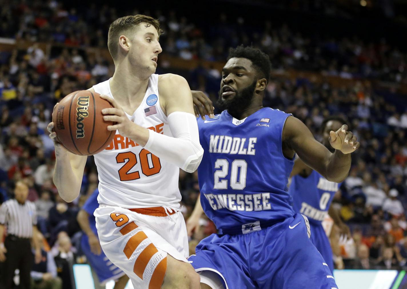 Syracuse's Tyler Lydon, left, looks to pass around Middle Tennessee's Giddy Potts during the second half of a second-round men's college basketball game in the NCAA Tournament, Sunday, March 20, 2016, in St. Louis. Syracuse won 75-50. (AP Photo/Jeff Roberson) ORG XMIT: MOJR121