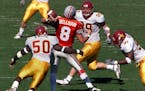 Ohio quarterback Steve Bellisari is rushed and sacked by Gophers Greg White #50, Matt Anderle #99 and Karon Riley #91 in fourth quarter action. ORG XM