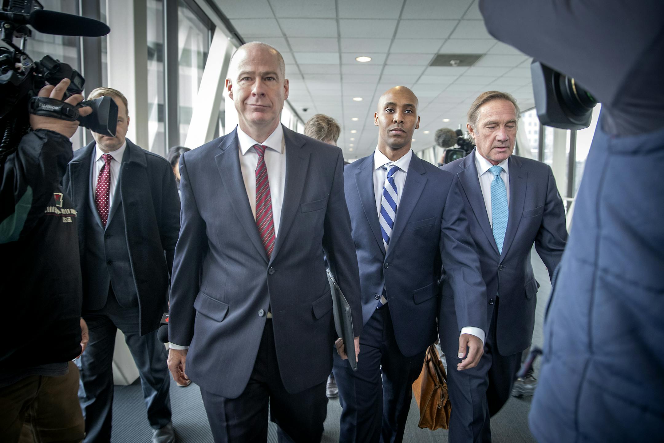 Former Minneapolis police officer Mohamed Noor, center, flanked by his attorneys, Thomas Plunkett, left, and Peter Wold, right, leaves Hennepin County Government Center after a pretrial motions hearing, Friday, March 1, 2019 in Minneapolis. Noor goes on trial April 1 in the death of Justine Ruszczyk Damond. She was shot when she approached Noor&#x2019;s squad car after making a 911 call. (Elizabeth Flores/Star Tribune via AP)