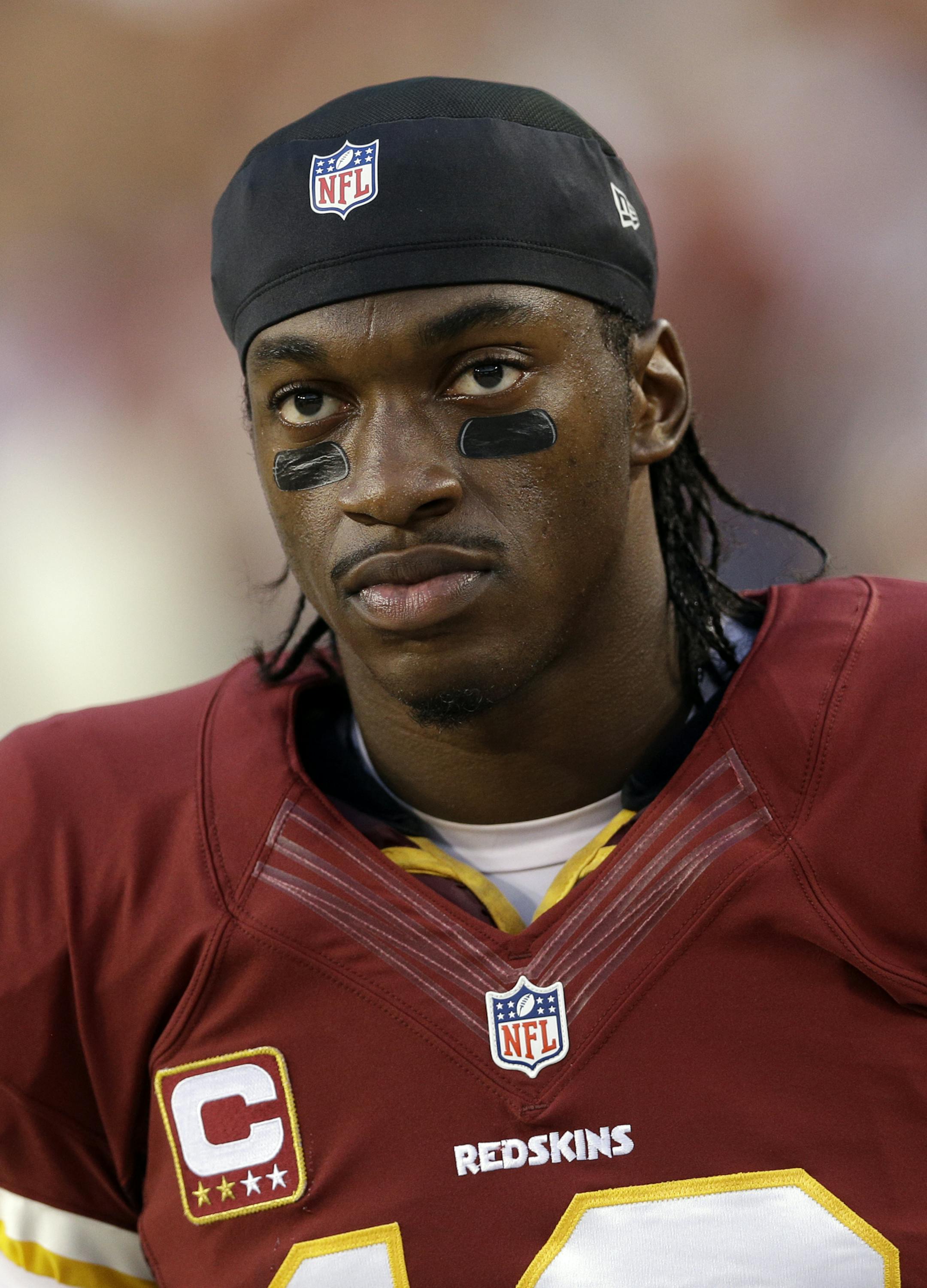 Washington Redskins quarterback Robert Griffin III walks along the sideline during the first half of a NFL football game against the Philadelphia Eagles in Landover, Md., Monday Sept. 9, 2013. (AP Photo/Patrick Semansky)