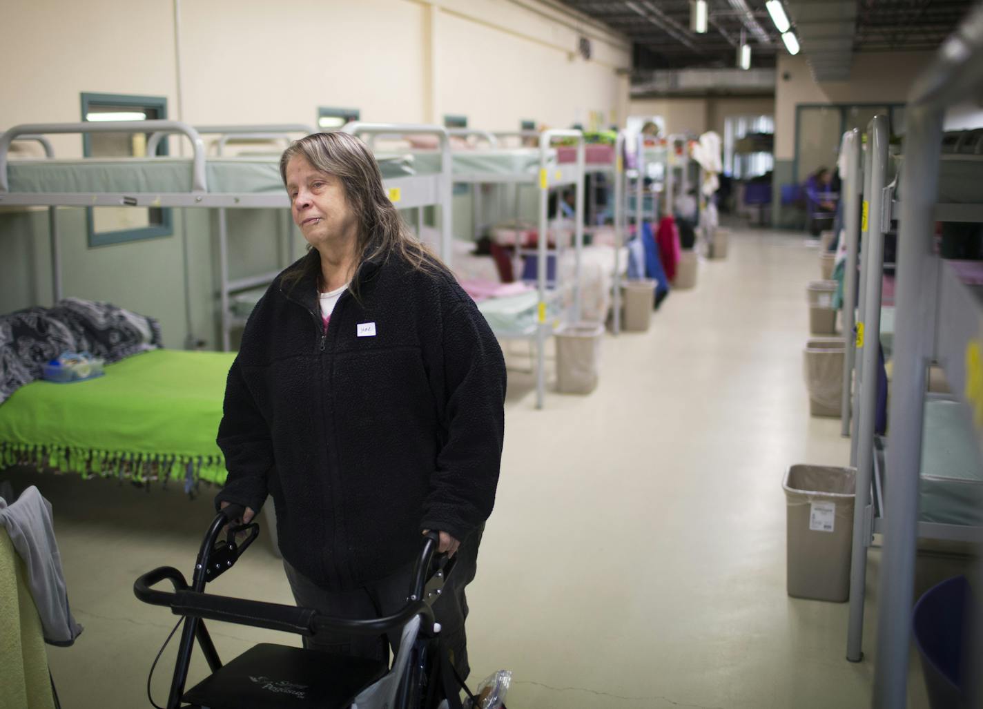 Jane Turner, 62, has been homeless for a year and a half and living at a shelter. Jane is part of a growing population of senior women who are homeless. She will be leaving Dorothy Day soon to move into an assisted living facility. She walked through the women's sleeping area at the Dorothy Day Center on Friday, April 24, 2015, in St. Paul, Minn. ] RENEE JONES SCHNEIDER &#x2022; reneejones@startribune.com