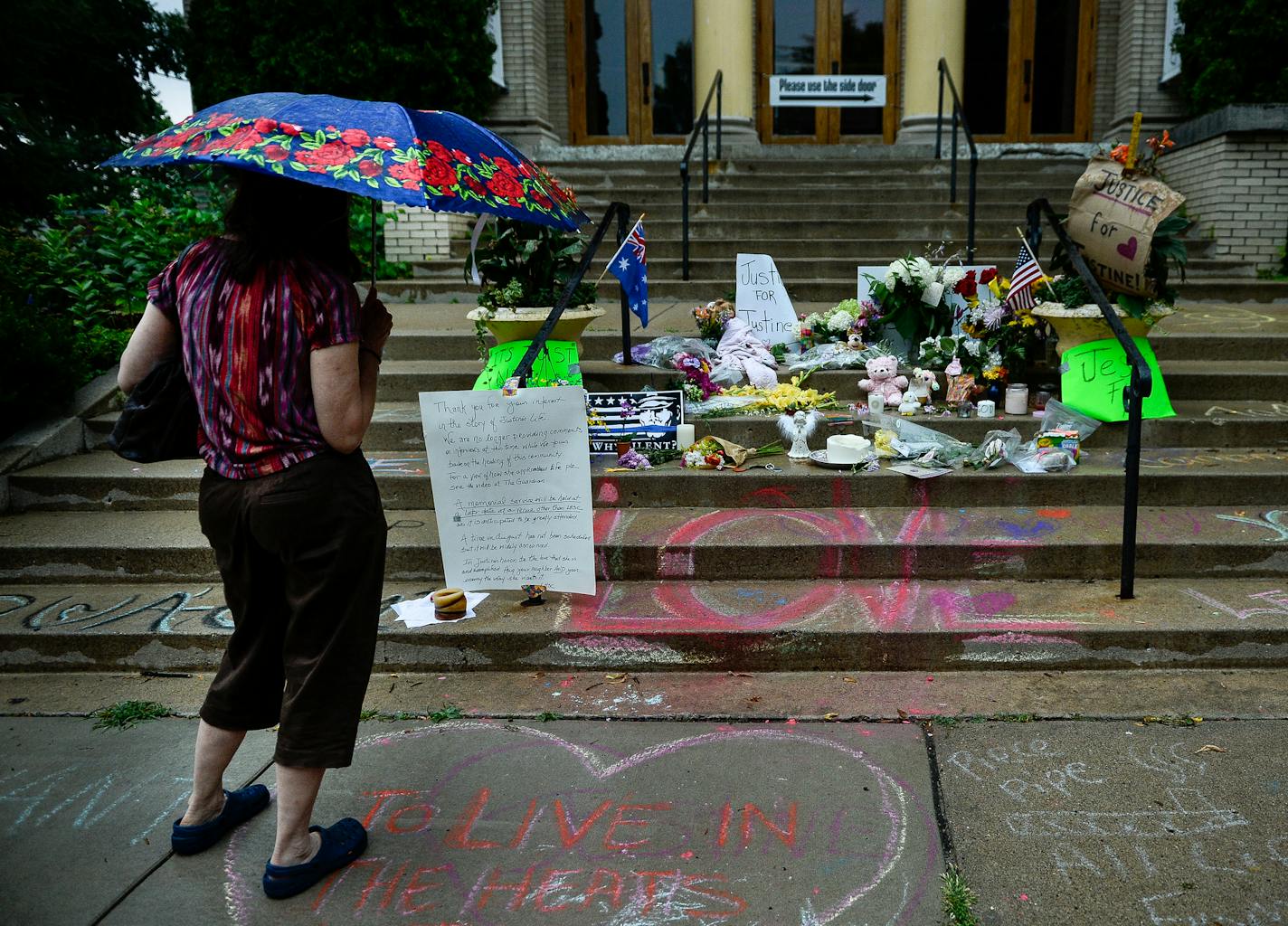 A woman viewed the memorial to Justine Damond on the steps of the Lake Harriet Spiritual Community building in south Minneapolis on Wednesday.