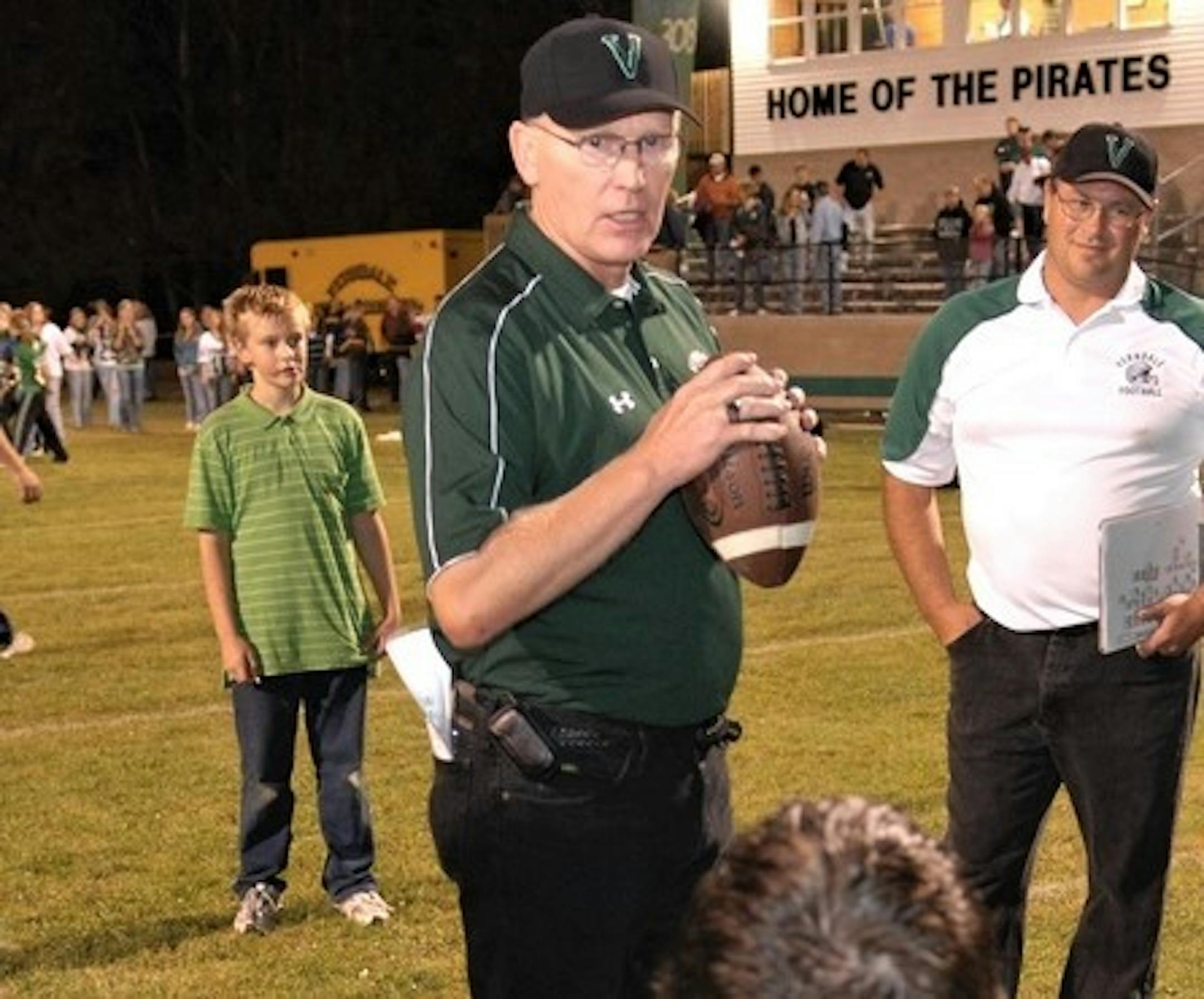 Verndale Minn. head football coach Mike Mahlen, center, talked to his team after defeating Bertha-Hewitt 40-6 in Verndale, Minn. on Friday, Sept. 19, 2008. With the win, Mahlen surpassed George Larson of Cambridge, Minn.  of 307 prep football wins. Mahlen topped the record with his 308th win. (Photo/Brainerd Dispatch, Steve Kohls)