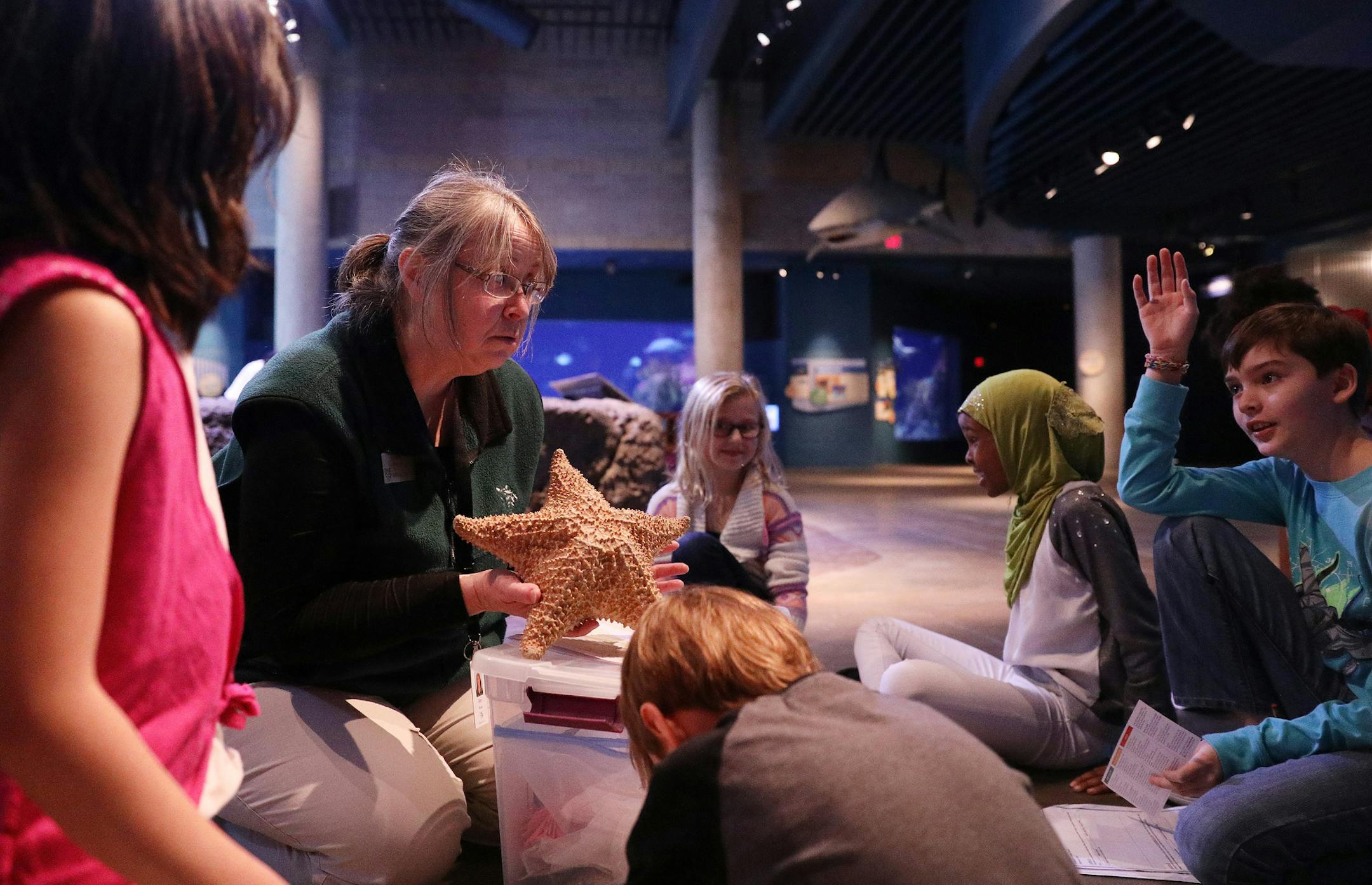 Ann Benusa, left, an interpretive naturalist with the Minnesota Zoo, talked to a group of Echo Park Elementary students about the needs to consider when designing a zoo animal's enclosure. ] ANTHONY SOUFFLE • anthony.souffle@startribune.com Echo Park Elementary Students from Burnsville spent the first day of a four day residency Tuesday, Jan. 11, 2016 at the Minnesota Zoo in Apple Valley, Minn. studying the snow monkeys to create a model exhibit for the animals.