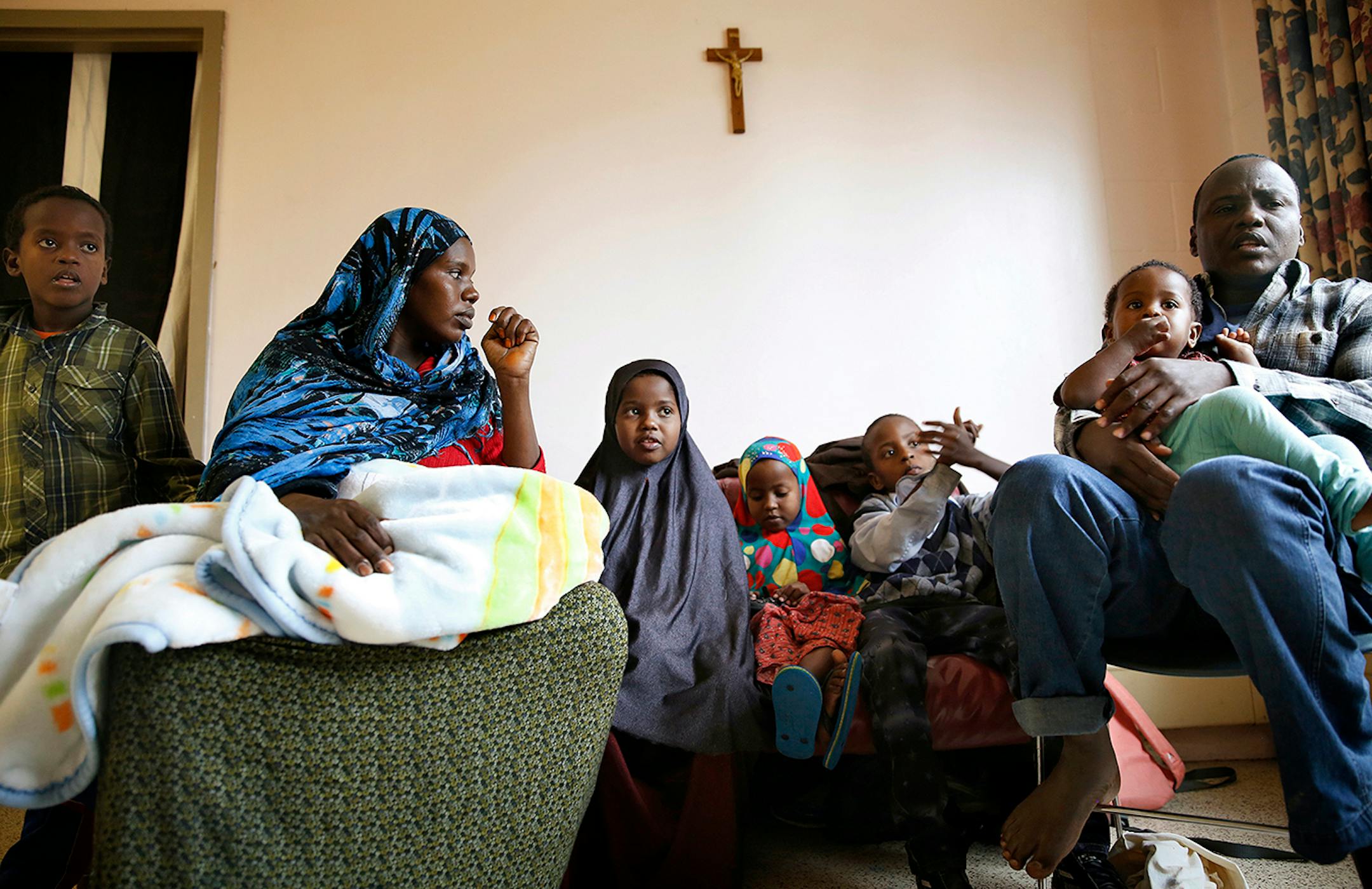 Recent Somali immigrants Nur Ali, right, and his wife Mahado Mohamed, left, sit with their six children Shukri Shukri, from left, 9, one-week-old Ifrah Shukri, in her mother's arms, Ugbad Shukri, 7, Hafifa Shukri, 4, Antar Shukri, 10, and one-year-old Ikra Shukri in their apartment at Mary's Place transitional apartments in downtown Minneapolis. The family arrived in the United States four months ago, first landing in Connecticut before coming to Minnesota. ] LEILA NAVIDI leila.navidi@startribun
