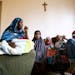Recent Somali immigrants Nur Ali, right, and his wife Mahado Mohamed, left, sit with their six children Shukri Shukri, from left, 9, one-week-old Ifra