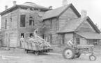 May 23, 1949 Wrecking of the old Donnelly home at Nininger, Minn., was well under way today under direction of Henry Trapp, (on load), who purchased t