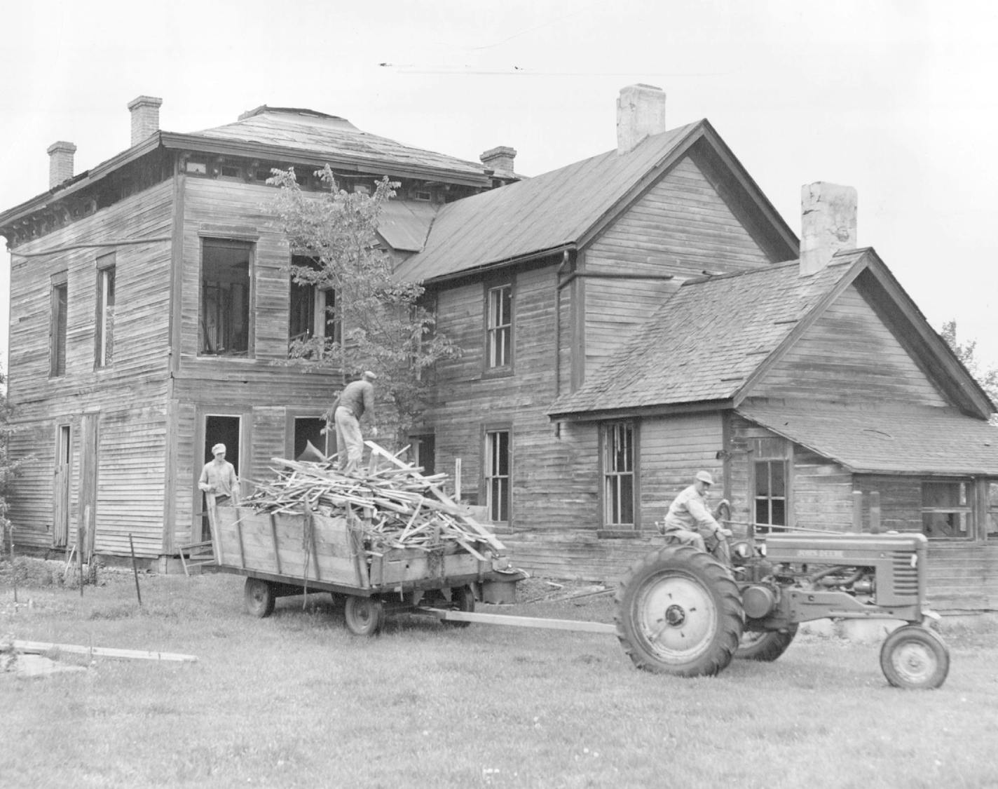 May 23, 1949 Wrecking of the old Donnelly home at Nininger, Minn., was well under way today under direction of Henry Trapp, (on load), who purchased the old home of famed Min&#xc2;&#xad;nesotan Ignatius Donnelly for $400. A move to save the historic building fell through&#xe2;&#x20ac;&#x2122; when inspection showed the structure was too far gone for rehabilitation. At left is A1 Rhoades, Hastings, and Walter Oestreich (on tractor), Fall River, Wis. Minneapolis Star Tribune