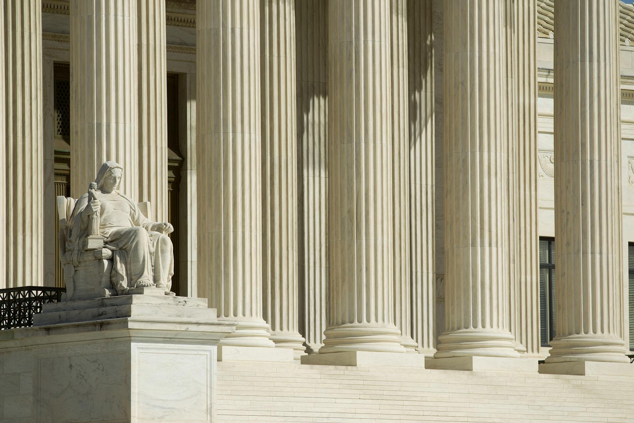 The "Contemplation of Justice" statue sits in front of the Supreme Court building in Washington, D.C., U.S., on Monday, March 26, 2012. The Supreme Court opens today its historic review of President Barack Obama's health-care law, three days of arguments that might result in the president's premier legislative achievement being found unconstitutional in the middle of his re-election campaign. Photographer: Andrew Harrer/Bloomberg