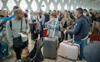 Passengers wait for their flights at the Marrakesh Airport on March 15, 2020. Several special flights departed Morocco, taking thousands of stranded E