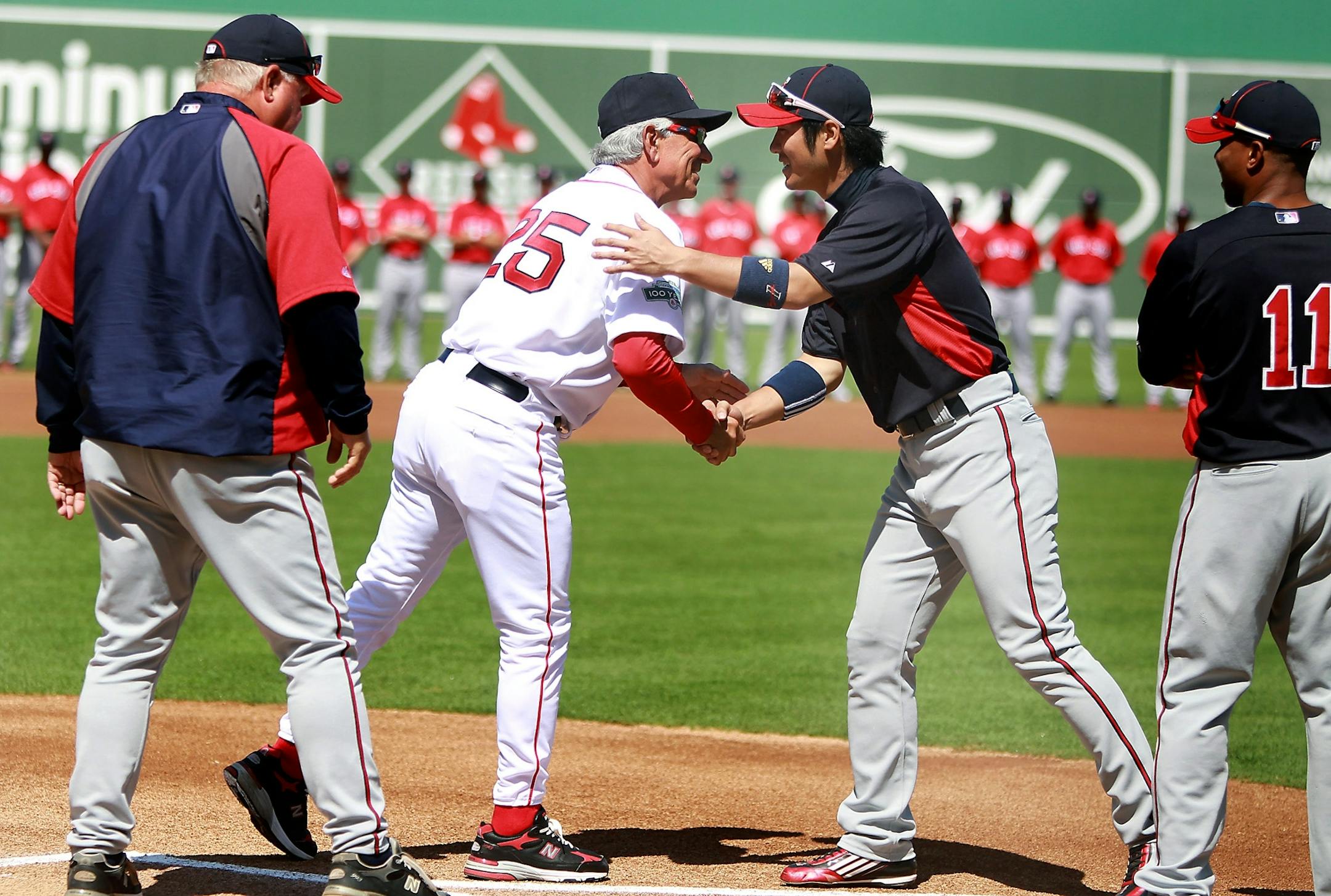 Boston Red Sox manager Bobby Valentine greeted former player Tsuyoshi Nishioka before the opening game for Boston in the new field known as JetBlue Park, Sunday, March 4, 2012.