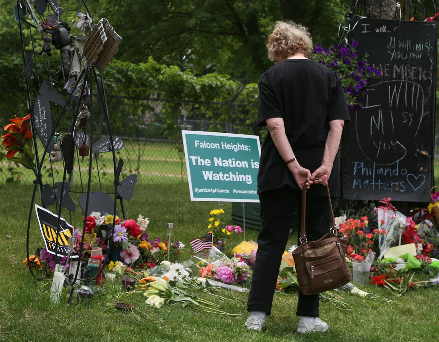 Friends Maureen Smith, left, and Constance Gruen, both of Roseville, look over the notes and flowers near the site where Philando Castile was fatally shot during a traffic stop by St. Anthony police Officer Jeronimo Yanez last July and seen Saturday, June 17, 2017, in Falcon Heights, MN. Yanez was acquitted of all charges in a verdict at the Ramsey County Courthouse Friday.] DAVID JOLES &#xef; david.joles@startribune.com Yanez aftermath**Maureen Smith and Constance Gruen,cq