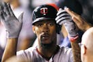 Minnesota Twins' Byron Buxton is congratulated in the dugout after hitting a home run during the sixth inning of a baseball game against the Kansas Ci
