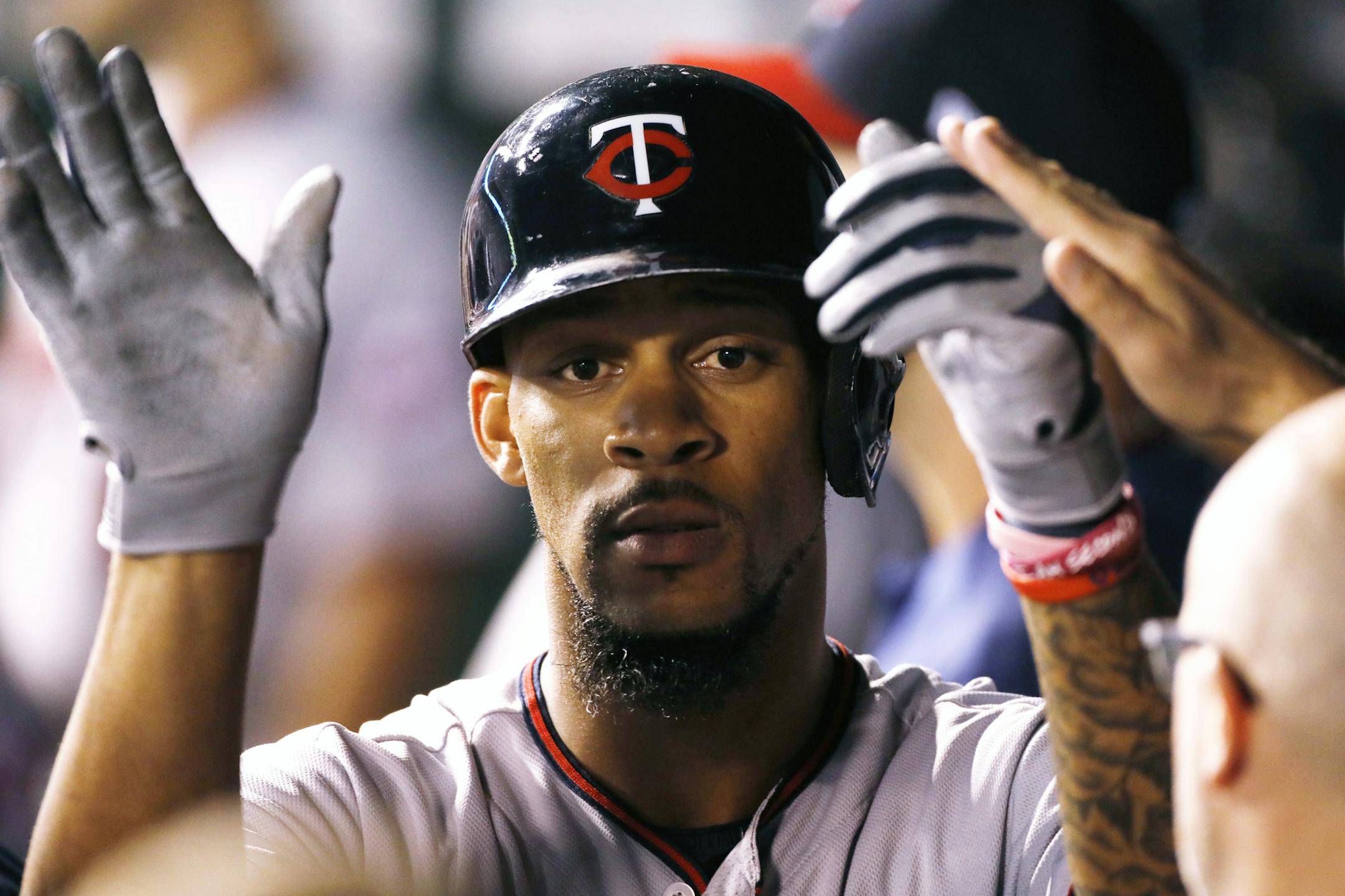 Minnesota Twins' Byron Buxton is congratulated in the dugout after hitting a home run during the sixth inning of a baseball game against the Kansas City Royals at Kauffman Stadium in Kansas City, Mo., Saturday Sept. 9, 2017. (AP Photo/Colin E. Braley)
