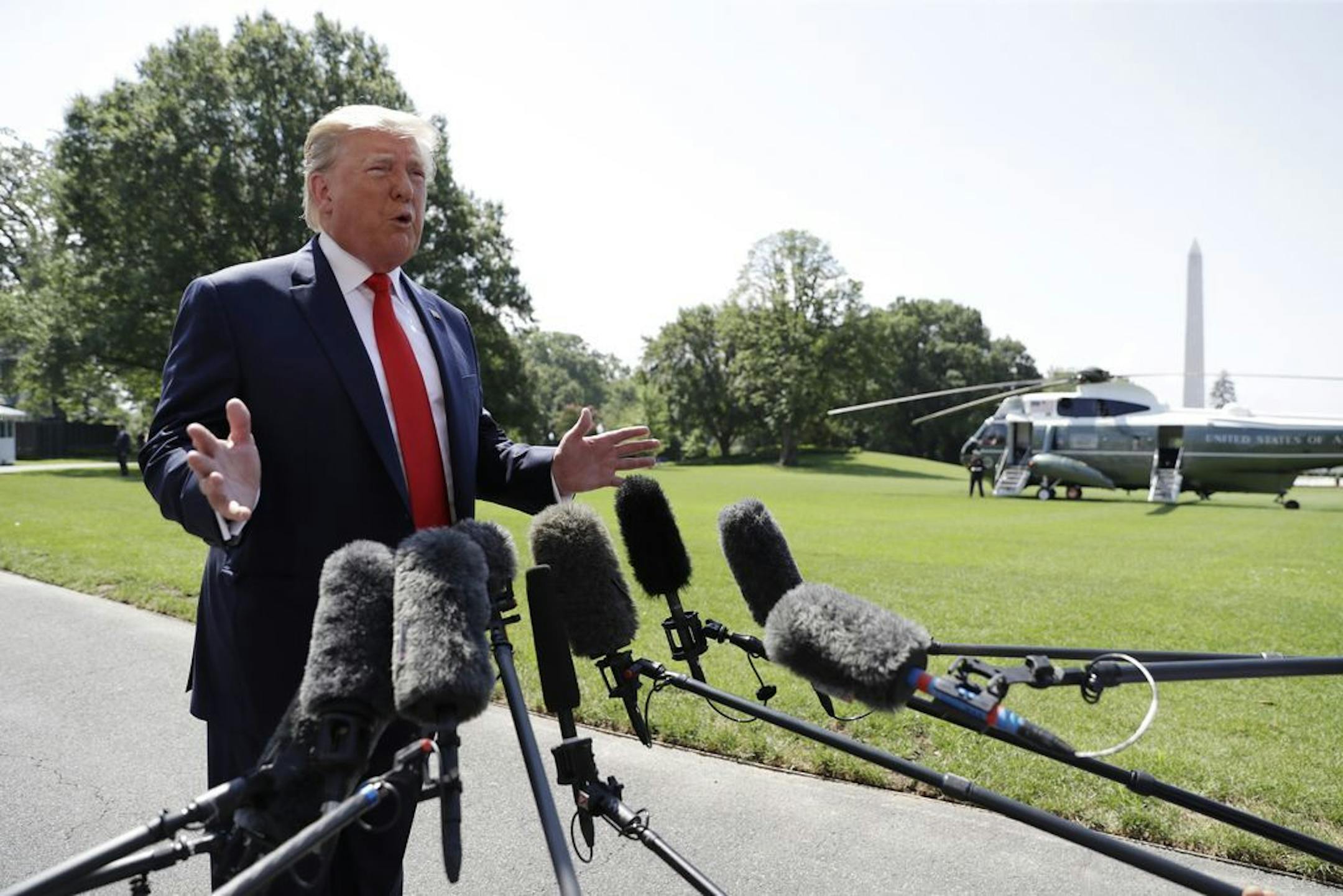 President Donald Trump talks to reporters on the South Lawn of the White House before departing for his Bedminster, N.J. golf club, Friday, July 5, 2019, in Washington.