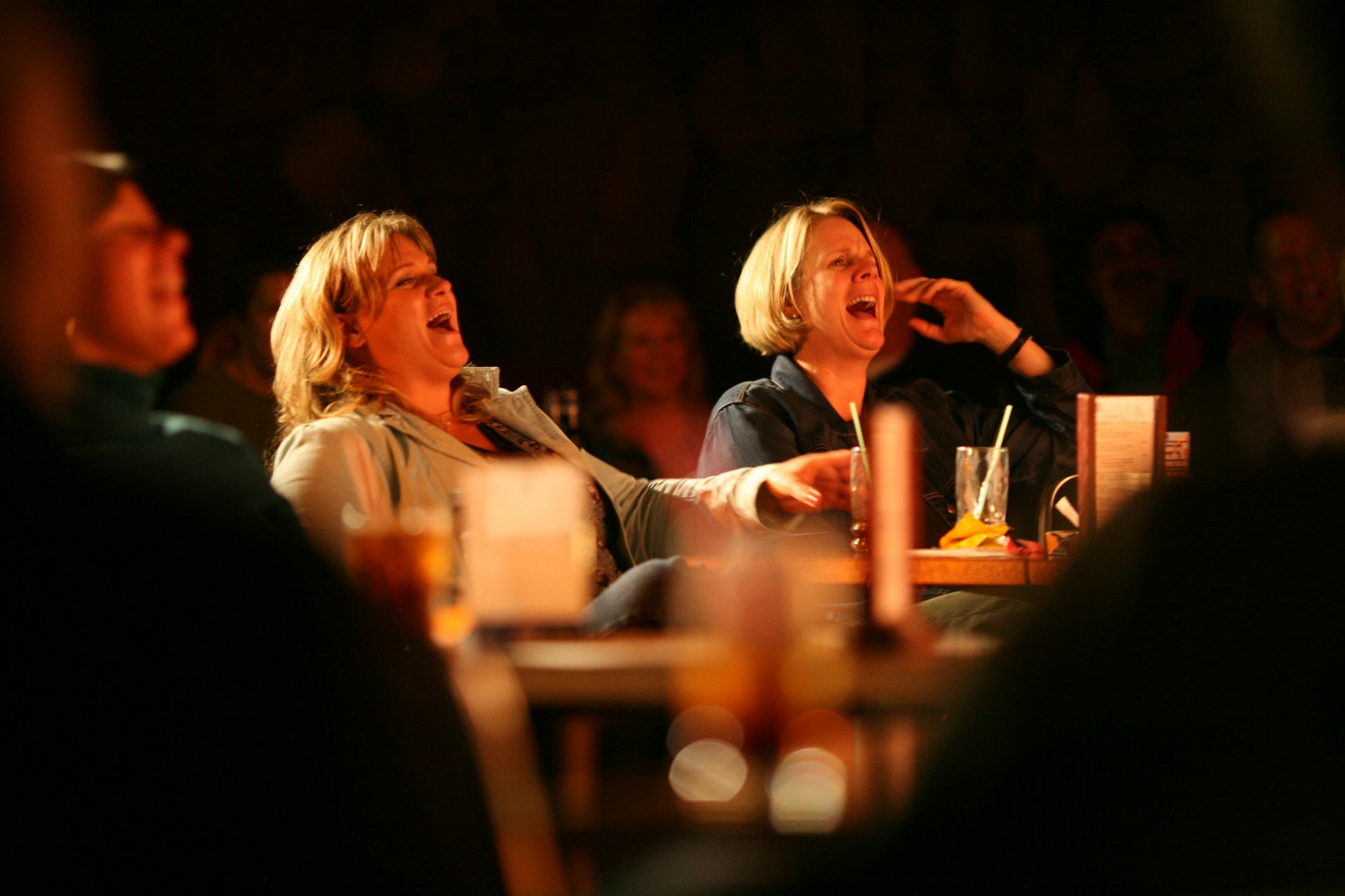 Nancy Olson, left, and Jean McCahey cracked up during John Knight's routine at the Joke Joint Friday night.