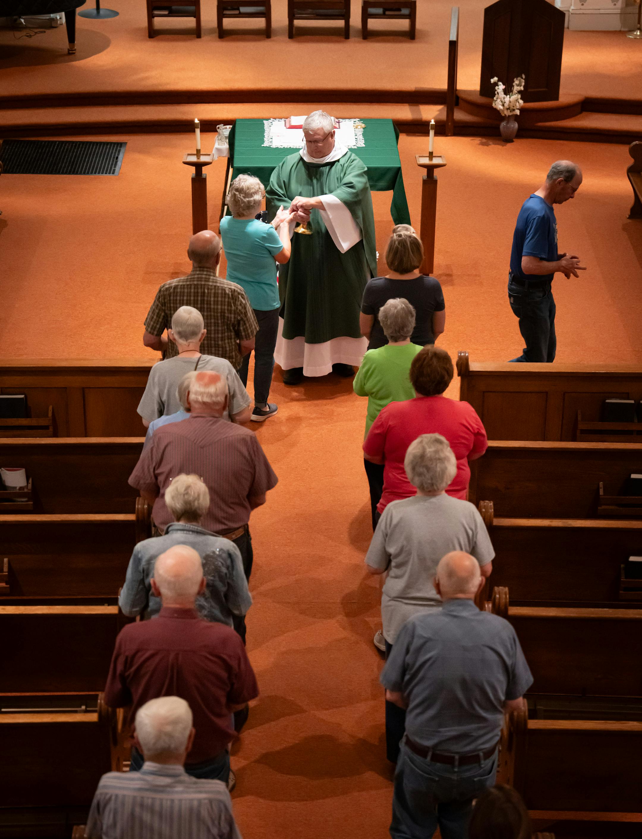 Parishoners stood in line to receive communion during Friday Mass at St. Joseph Church.