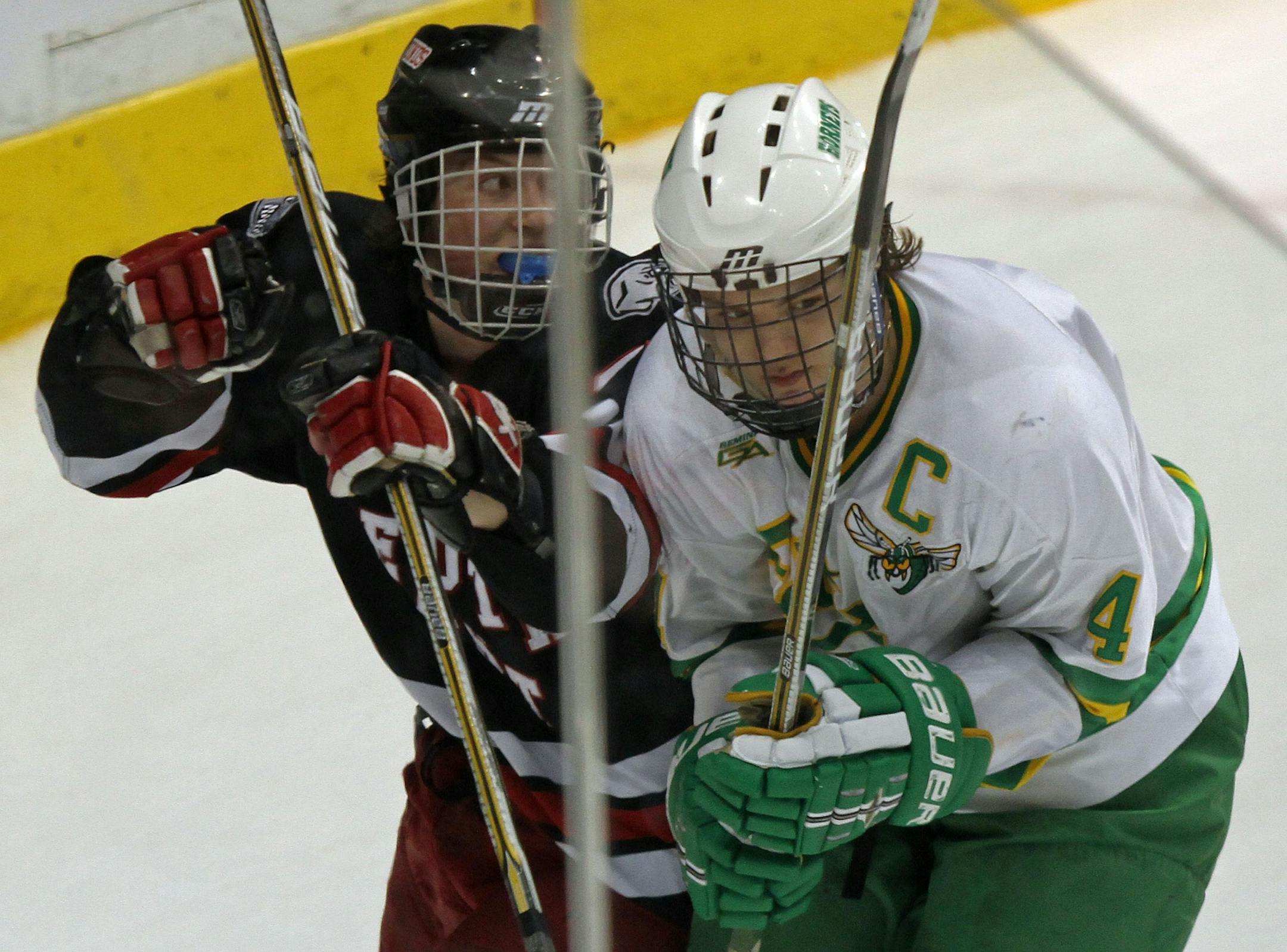 Max Everson (right) during the 2011 Class 2A hockey tournament. On the left is Duluth East's Alex Toscano.