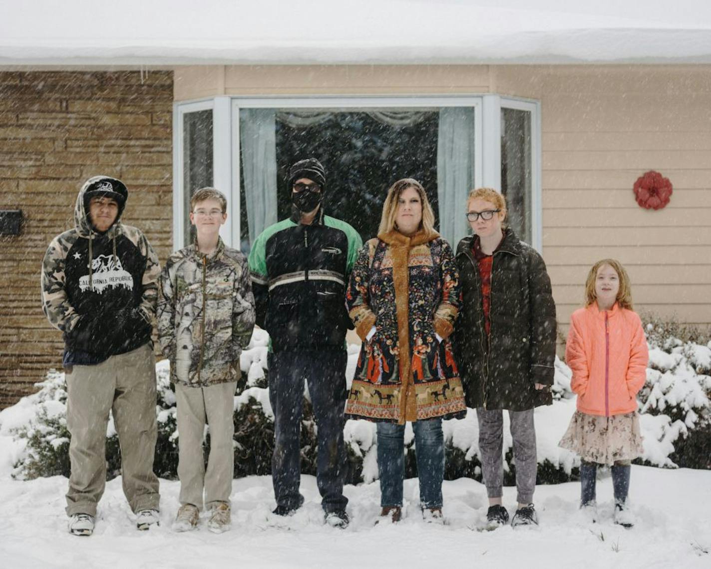 Holly Sortland, center, who contracted COVID-19 along with her husband, with her family outside of their home in Rapid City, S.D., Oct. 24, 2020. Infectious-disease experts had warned about the dangers of cramming thousands of revelers into the Black Hills of South Dakota at the height of a pandemic, but it was the 80th anniversary of the annual Sturgis rally, and bikers were coming no matter what.