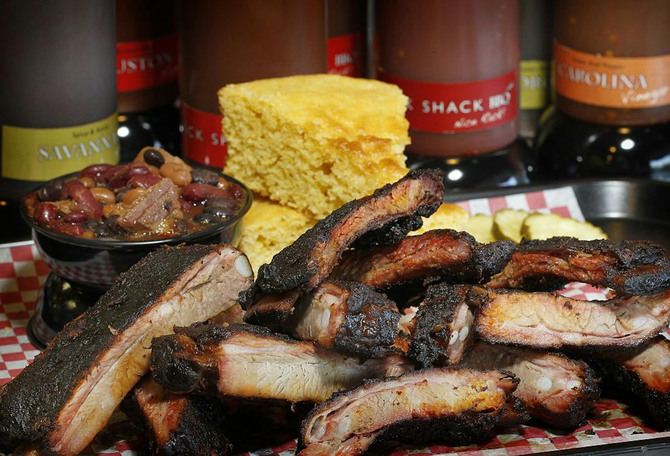 A pile of rib, the Rack O' Ribs corn bread and beans with plenty of flavors for sauce.es Rack Shack, 2925 E. Cliff Rd., Burnsville, 952-736-3004, co-owner From left, Keith Jr. Hittner, Keith Sr. Hittner,and Elliott Ashwell. The is a Pulled pork sandwich, rack of ribs. [ TOM WALLACE � twallace@startribune.com _ Assignments #20025127A_ August 29, 2012_ SLUG: rn0906_ EXTRA INFORMATION: Rick Nelson