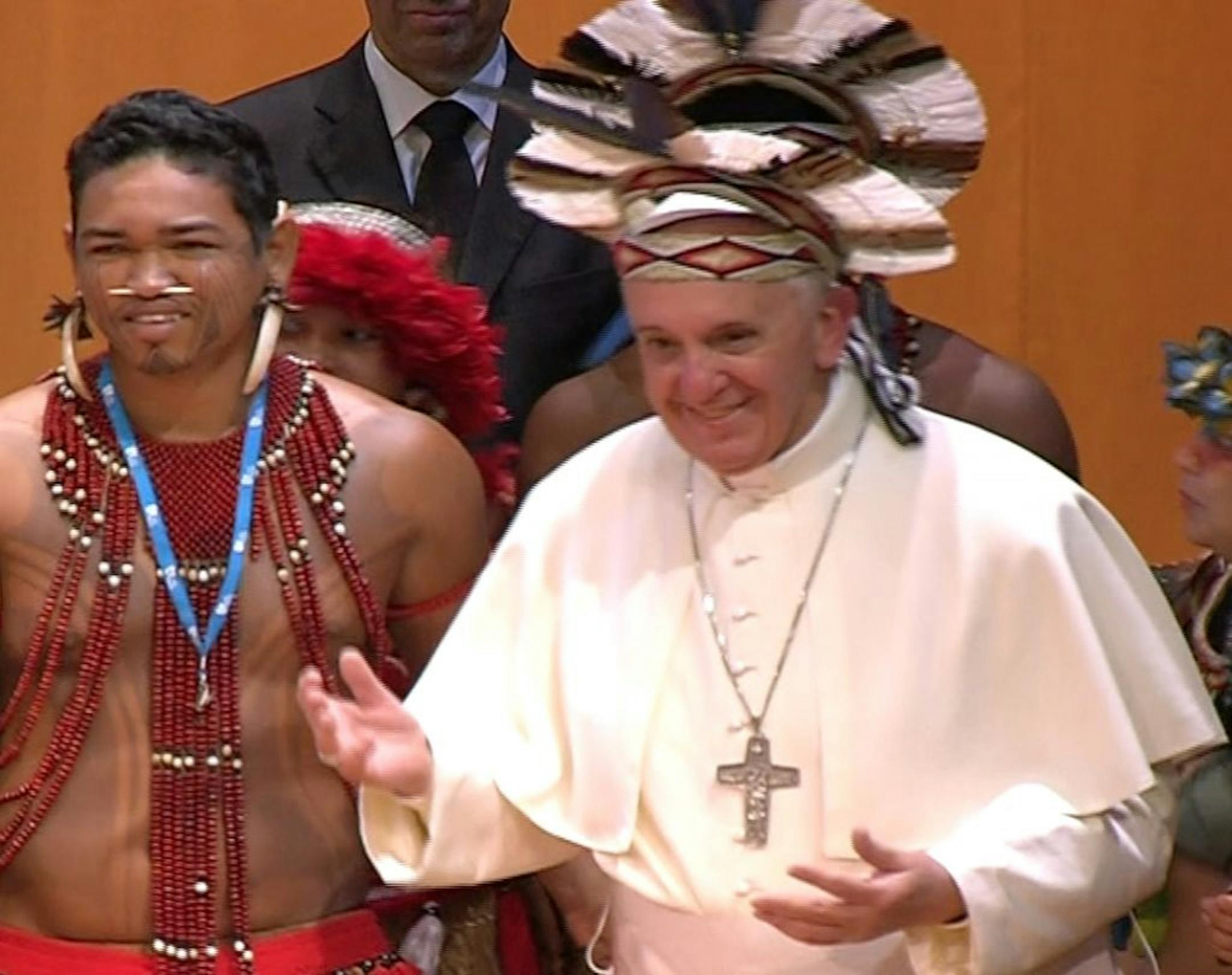 In this frame grab from video Pope Francis wears an indigenous feather hat given to him by representatives of one of Brazil's native tribes during a meeting at the Municipal Theater in Rio de Janeiro, Brazil, Saturday, July 27, 2013. Pope Francis is on the sixth day of his trip to Brazil where he will attend the 2013 World Youth Day in Rio.