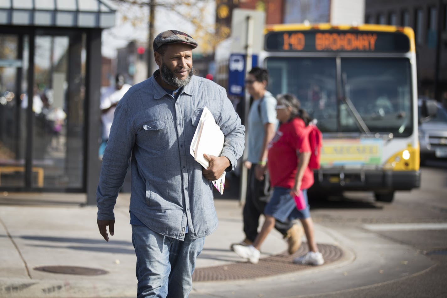 Chaka Mklai spreads the word about the voter bus in north Minneapolis.