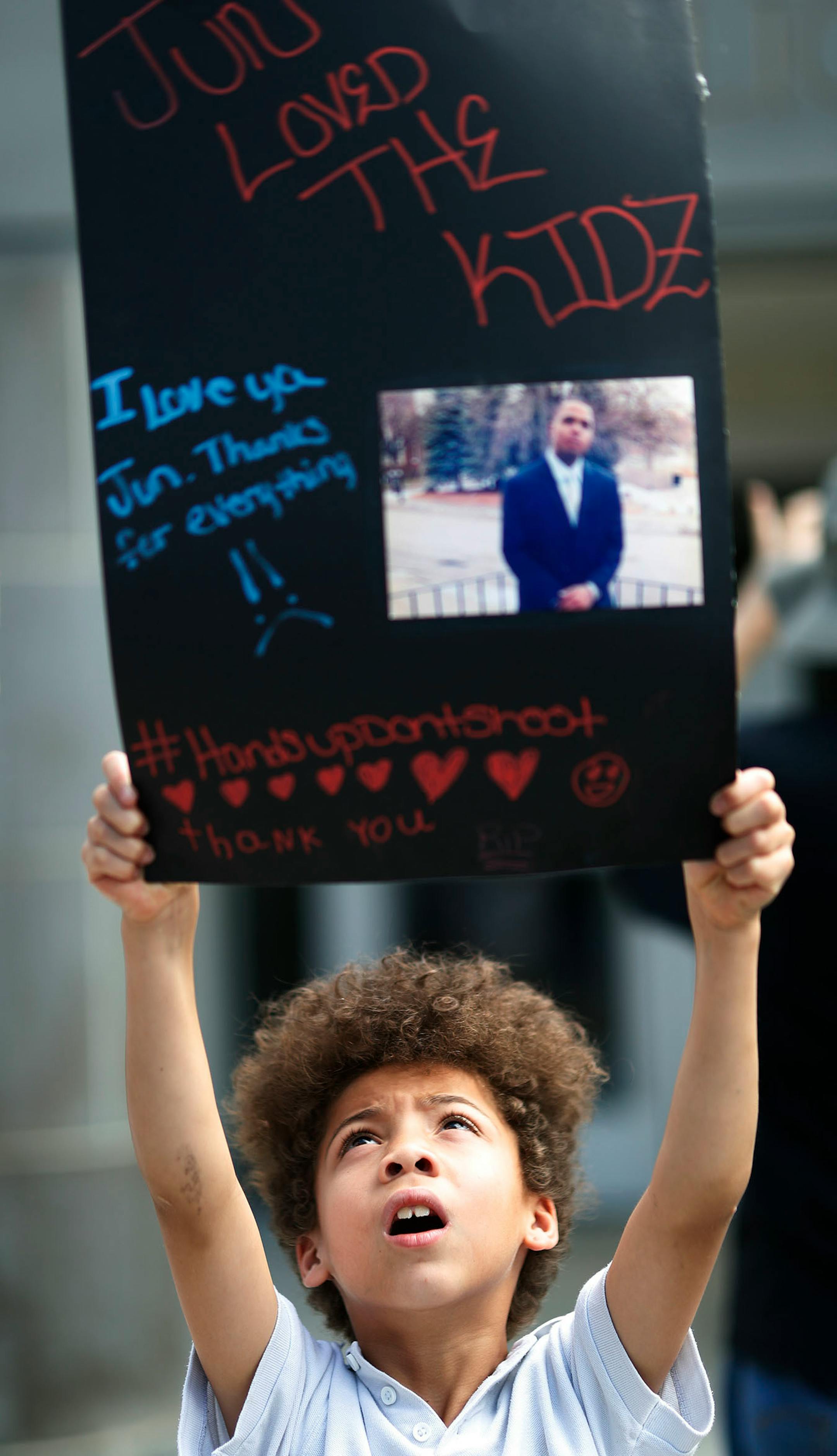 Mitiae Chamberlain 7, held a poster of Thurman Blevins during protest and rally at the Fourth Precinct on Plymouth Avenue in response to the shooting death of Thurman Blevins by Minneapolis Police.