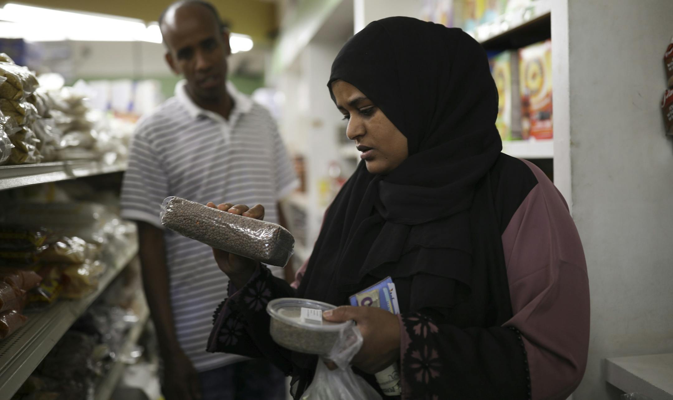 Meliha Besher looked at package of brown lentils while browsing in the aisles of Wadajir Grocer Wednesday afternoon for provisions to break the fast of Ramadan. ] JEFF WHEELER ï jeff.wheeler@startribune.com It was busy at Wadajir Grocery & Halal Meat market on Cedar Ave. S. Wednesday afternoon, May 16, 2018 with a steady stream of neighborhood residents stocking up on traditional foods eaten to break the fast at the start of Ramadan.
