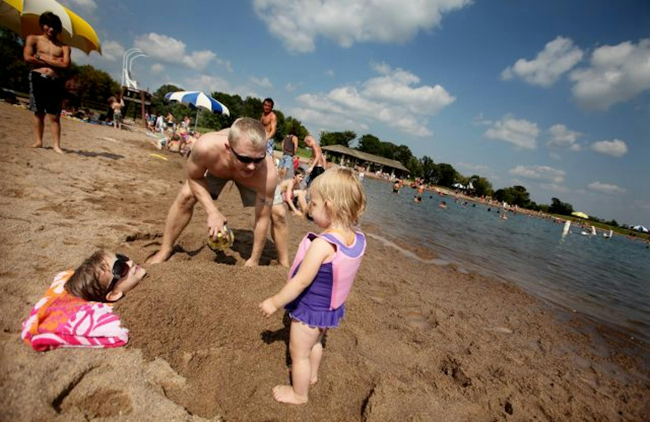 ELIZABETH FLORES eflores@startribune.com September 6, 2009 - Lake Elmo, MN - Nate Koch took some time with his family to play at the Lake Elmo beach area with daughters Sherlby Koch, 5, in sand and Cheyenne Koch, 19 months, at the Lake Elmo Park Reserve. Many Labor Day vacationers enjoyed the reserve with a beach, campgrounds, fishing, picnics, and a trail area.
