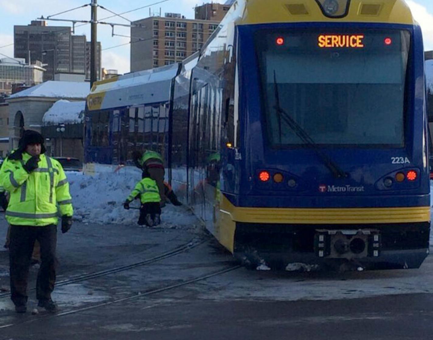 A light rail train went off the rails on a curve at 12th and Cedar in St. Paul on Wednesday, Feb. 26, 2014. Workers are trying to shovel out the back end of the train to free it.