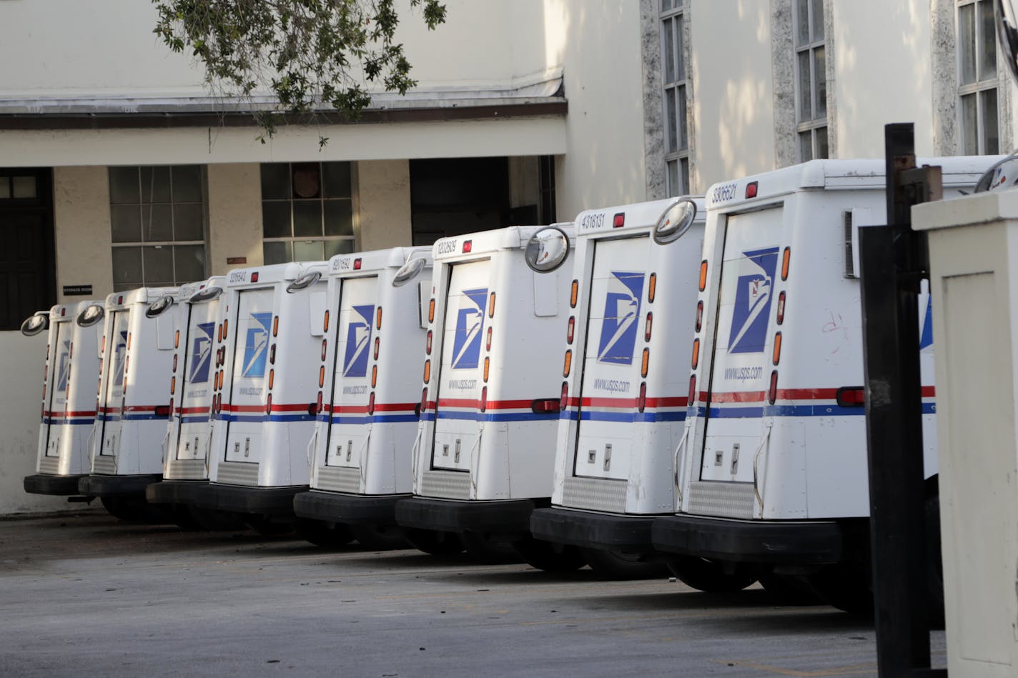 United States Postal Service trucks are lined up during the new coronavirus pandemic, Monday, April 13, 2020, in Miami Beach, Fla. (AP Photo/Lynne Sladky)