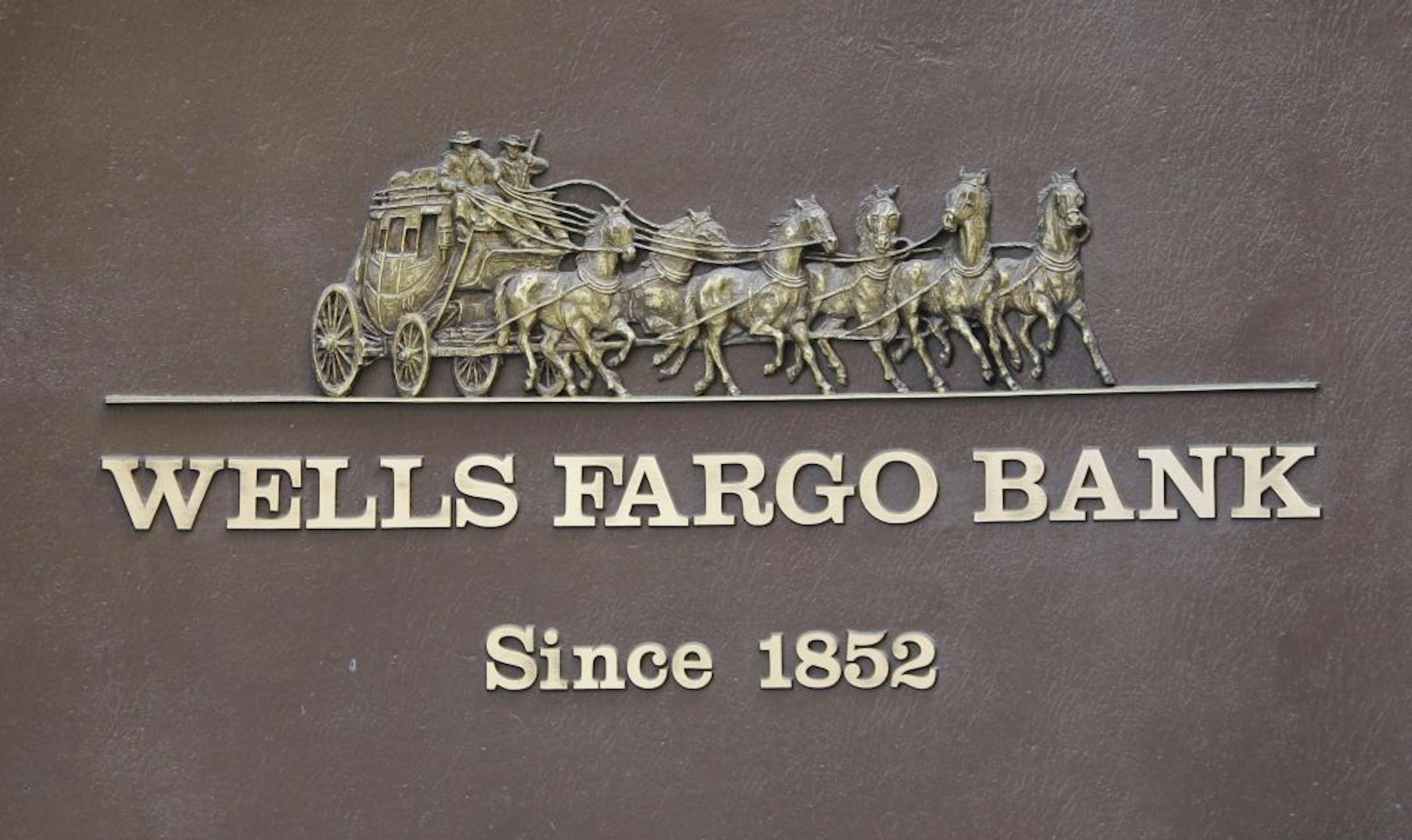 In this Oct. 7, 2010 photo, the logo for Wells Fargo Bank is displayed in downtown San Francisco Wells Fargo & Co. said Wednesday, Oct. 20, its third-quarter profit rose 19 percent and beat forecast as losses from failed loans fell for the third straight quarter.