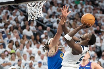 Denver Nuggets forward Aaron Gordon, left, defends a shot attempt by Minnesota Timberwolves guard Anthony Edwards during the third quarter of Game 3 o