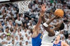 Denver Nuggets forward Aaron Gordon, left, defends a shot attempt by Minnesota Timberwolves guard Anthony Edwards during the third quarter of Game 3 o