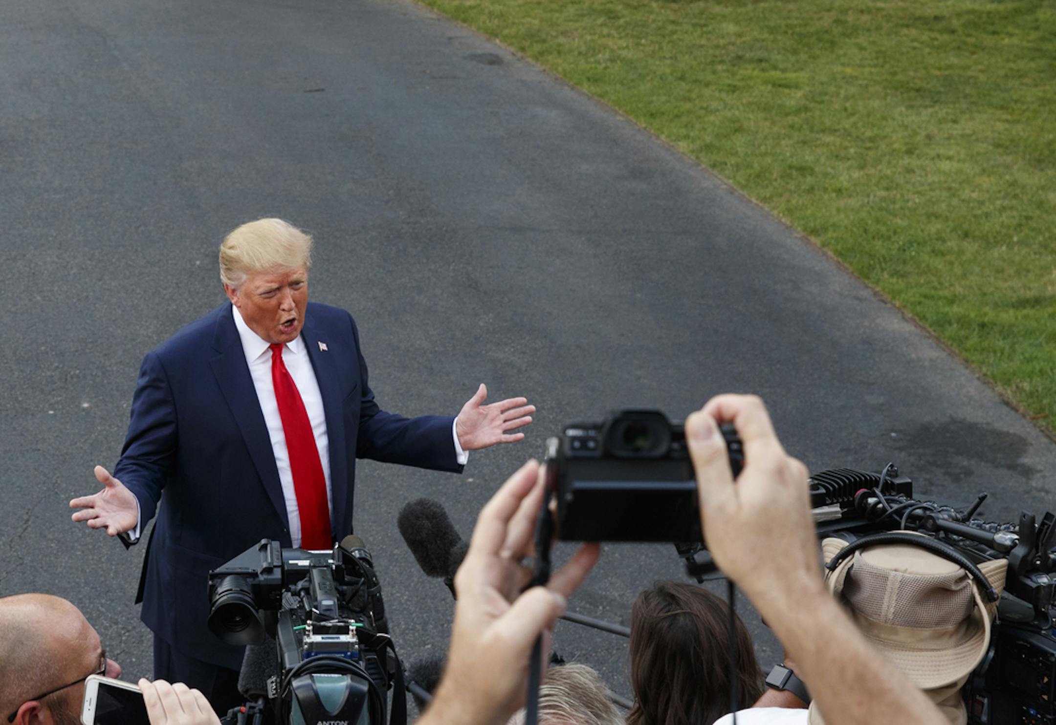 President Donald Trump speaks to media as he leaves the White House in Washington, Thursday, Aug. 1, 2019, for the the short trip to Andrews Air Force Base, Md., and on to a campaign rally in Cincinnati. (AP Photo/Carolyn Kaster)