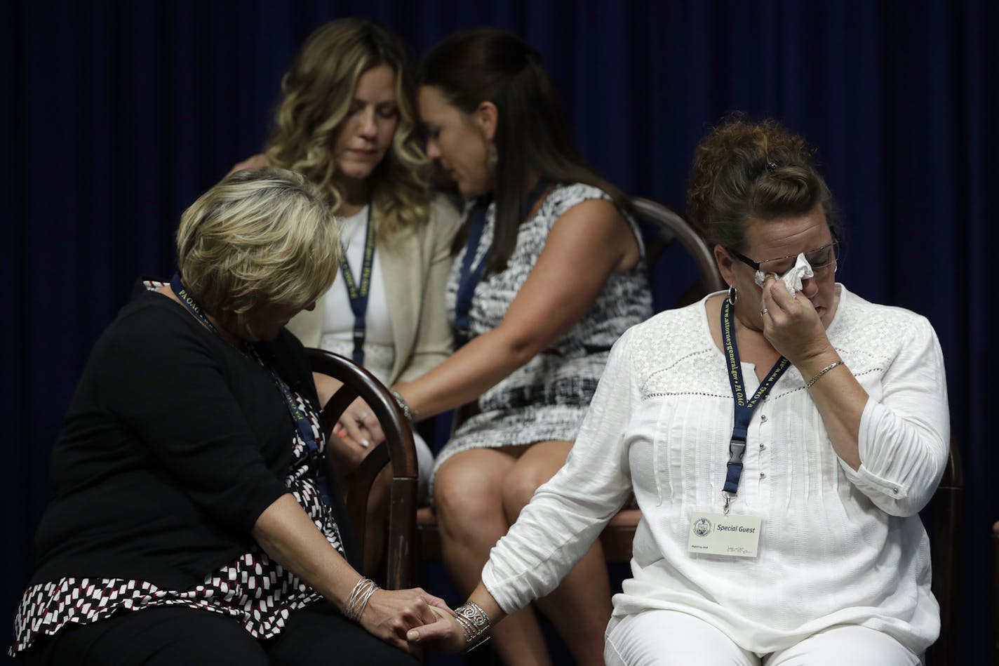 Victims of clergy sexual abuse, or their family members react as Pennsylvania Attorney General Josh Shapiro speaks during a news conference at the Pennsylvania Capitol in Harrisburg, Pa., Tuesday, Aug. 14, 2018. A Pennsylvania grand jury says its investigation of clergy sexual abuse identified more than 1,000 child victims. The grand jury report released Tuesday says that number comes from records in six Roman Catholic dioceses. (AP Photo/Matt Rourke)