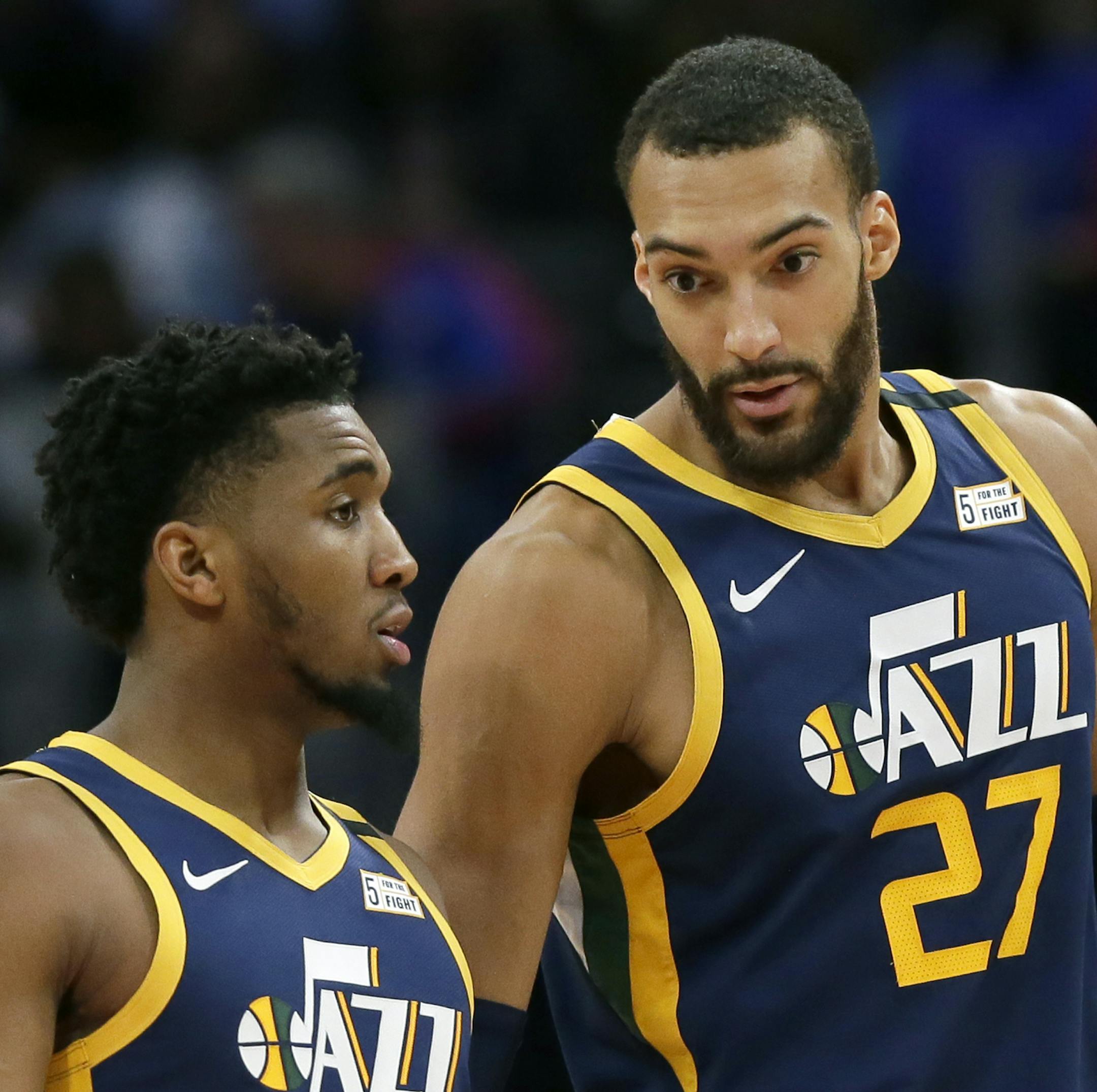FILE - In this Saturday, March 7, 2020, file photo, Utah Jazz center Rudy Gobert (27) talks with guard Donovan Mitchell, left, during the second half of an NBA basketball game against the Detroit Pistons, in Detroit. Both players have tested positive for the coronavirus. Gobert's test result forced the NBA to suspend the season. (AP Photo/Duane Burleson, File)