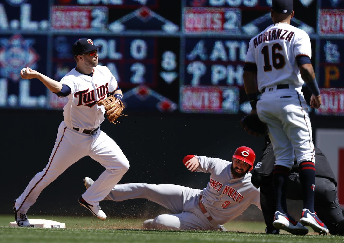 The Reds' Jose Peraza is forced out at second base by Brian Dozier, who is in a hitting slump.