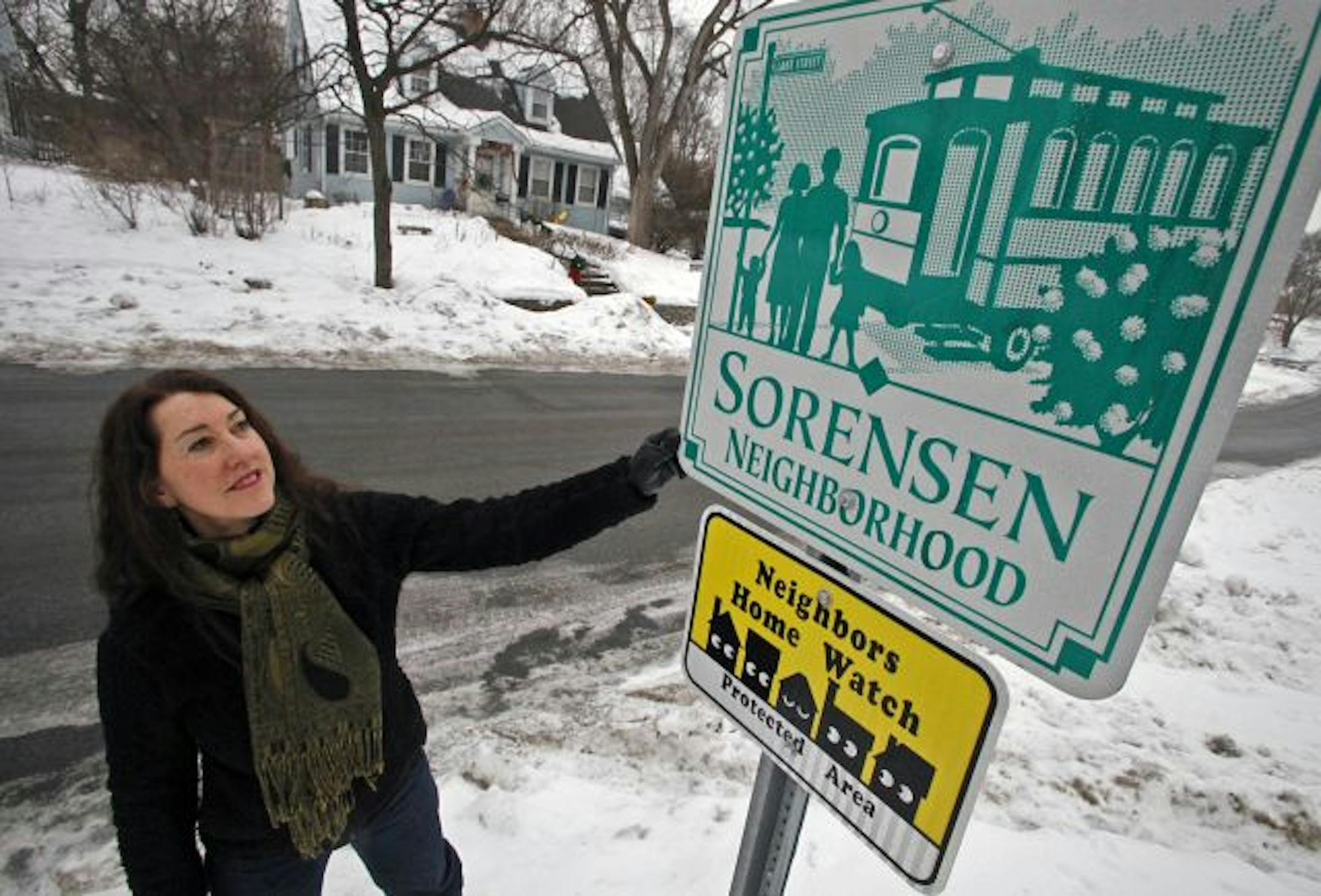 Lois Zander, president of the Sorenson Neighborhood Association, inspected a sign recently installed in the St. Louis Park area identifying it as a neighborhood. Having an official status has help create a sense of community, she said.