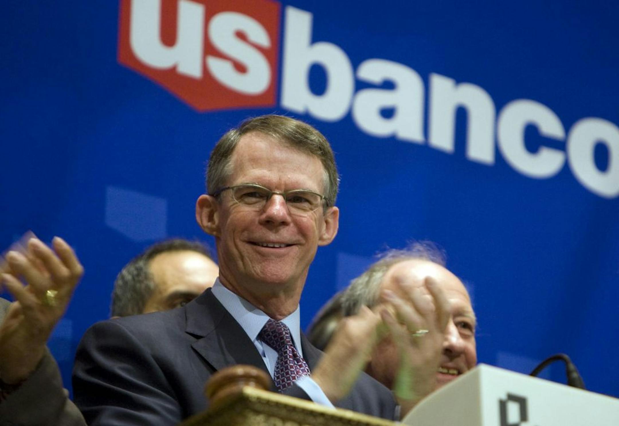 (File) Richard Davis, president and chief executive officer of U.S. Bancorp, applauds before ringing the closing bell at the New York Stock Exchange.