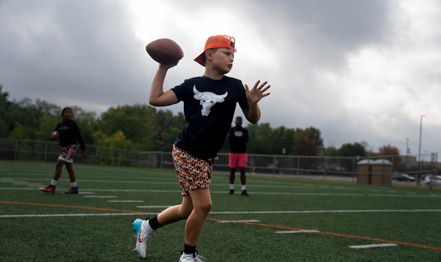 Baylor Smith, 10, was one of the young quarterbacks running drills last weekend with Cleveland McCoy.