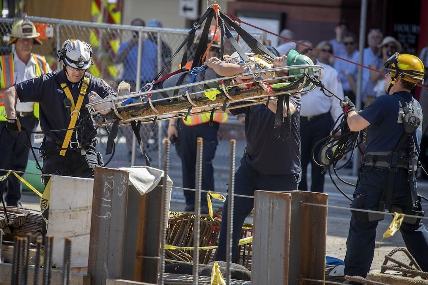 A worker was lifted to safety by Minneapolis and St. Paul fire fighters after being trapped below ground for three hours at a construction site on the corner of Park and Washington avenues in downtown Minneapolis Monday.