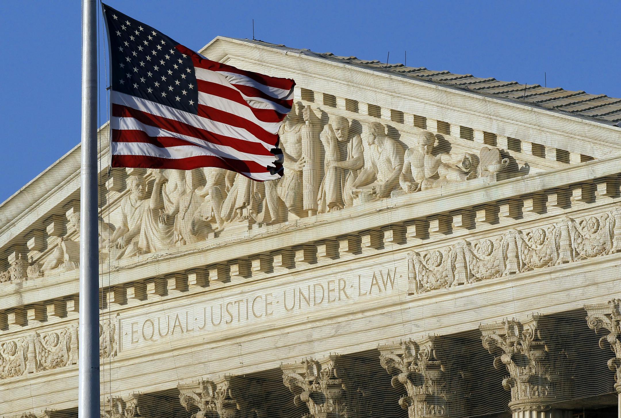 An American flag flies in front of the Supreme Court building in Washington.