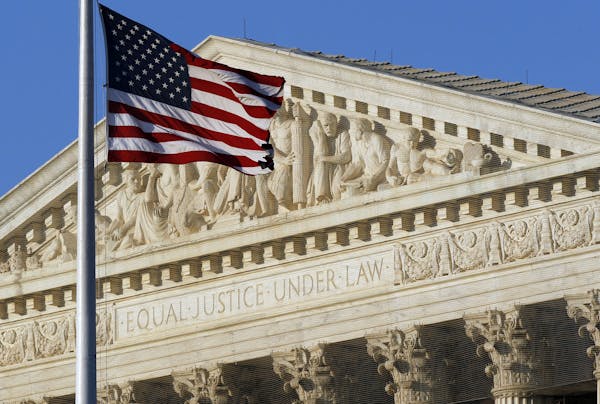 An American flag flies in front of the Supreme Court building in Washington.