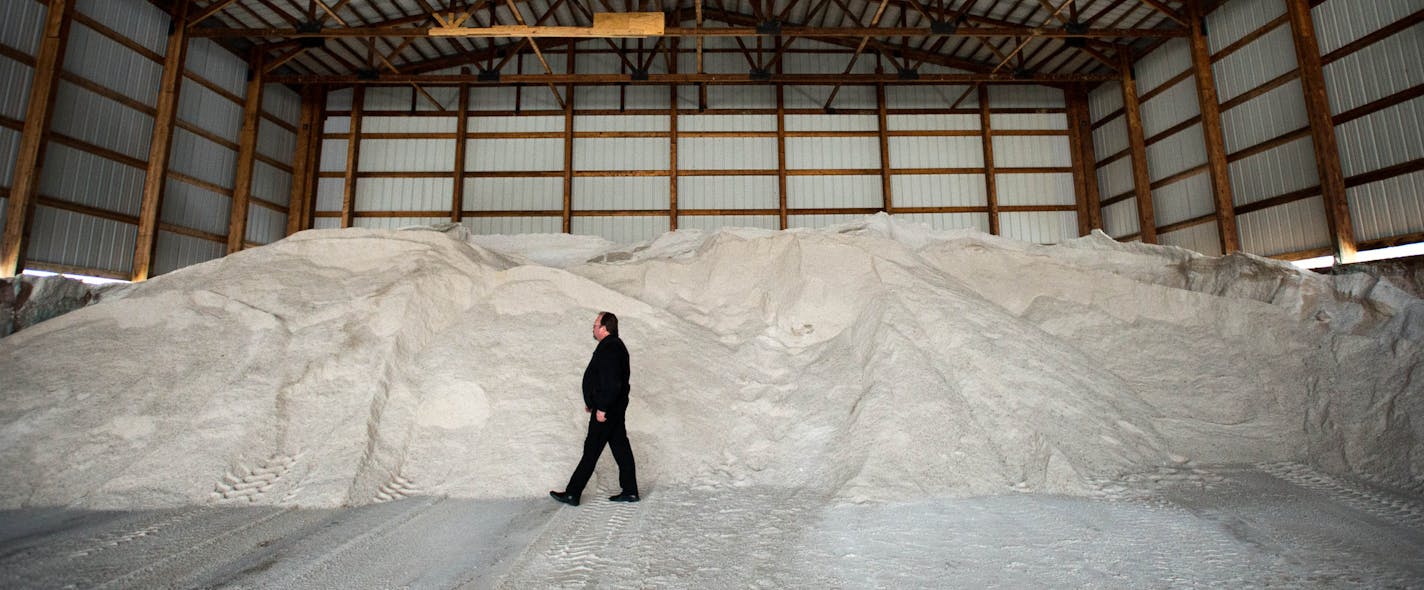 Minnesota Department of Transportation Communications Specialist Kent Barnard walks next to the salt pile at the Arden Hills Truck Station to give it a sense of scale. ] AARON LAVINSKY &#x2022; aaron.lavinsky@startribune.com The University of Minnesota cut its salt use by 41 percent. Joe's Lawn and Snow service is buying half as much as it used to. And Waconia has reduced its salt use by a whopping 70 percent -- all without sacrificing safety. As the number of contaminated lakes and streams in t