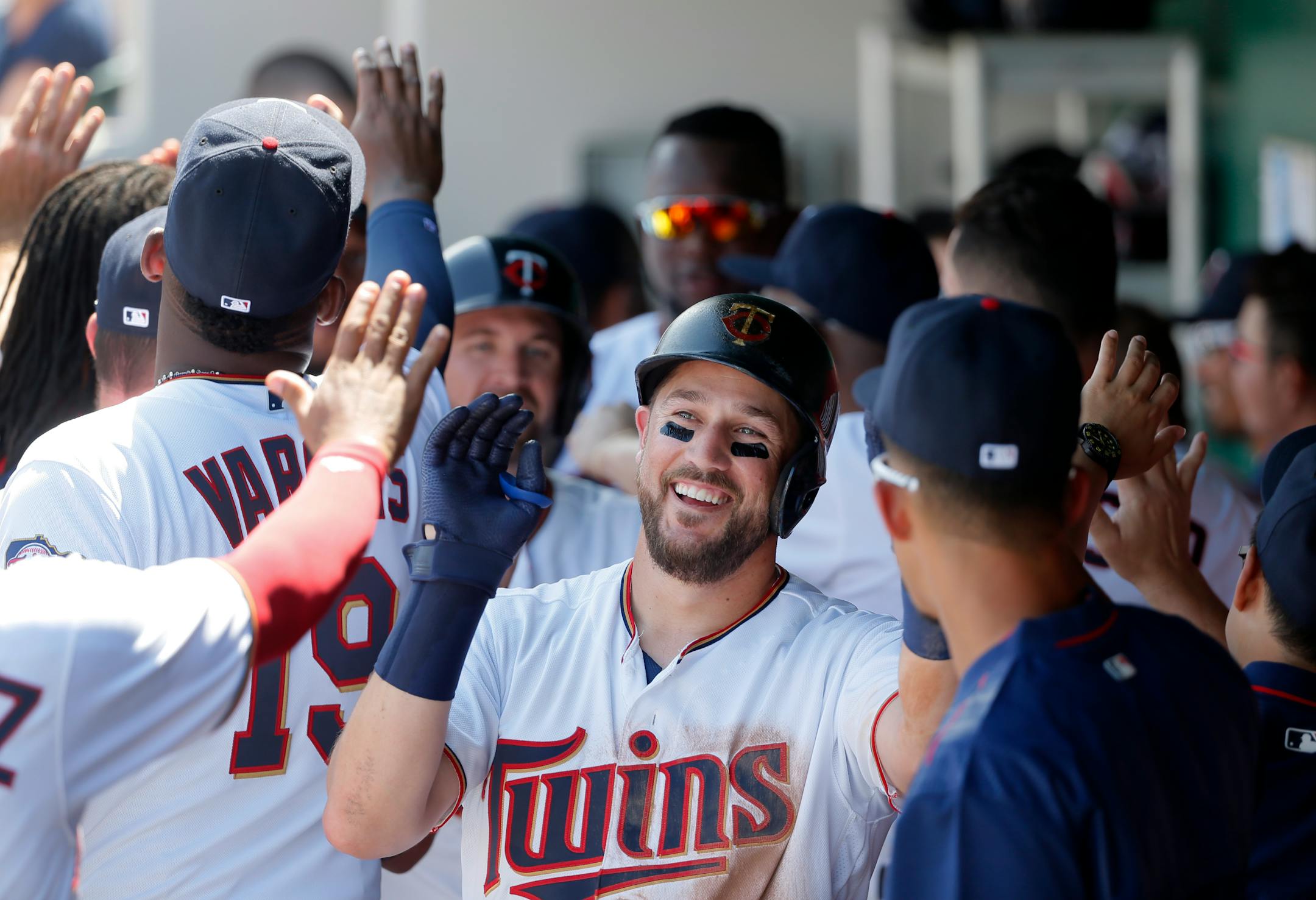 The Twins' Trevor Plouffe, center, was congratulated in the dugout after his three-run home room off Orioles starter Miguel Gonzalez in the second inning Sunday in Fort Myers, Fla.