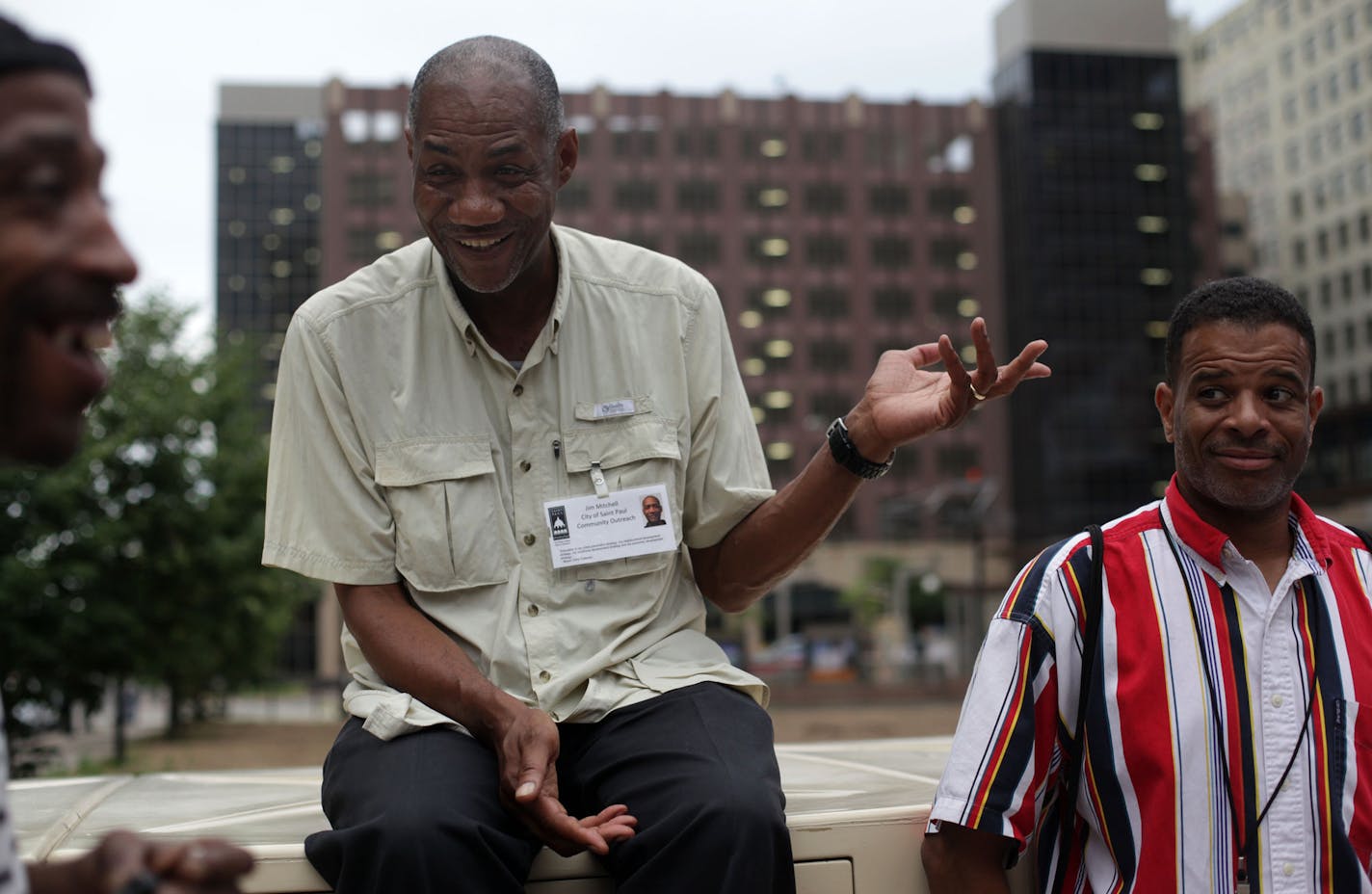 Jim Mitchell and Damon Drake, the community ambassador coordinator, engage with area youth as they pass by on Friday evening. ] Area youth workers patrol the streets of St. Paul to engage with youth. MONICA HERNDON monica.herndon@startribune.com St. Paul, MN 07/25/14