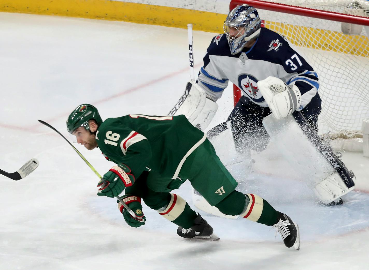 The Minnesota Wild's Jason Zucker (16) skates near Winnipeg goalie Connor Hellebuyck (37) during the Wild's 4-1 win over the Winnipeg Jets on Jan. 13, 2018.